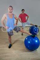 Men exercising with exercise ball