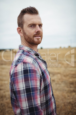 Portrait of farmer standing in the field