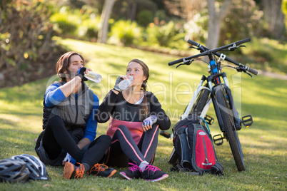 Biker couple relaxing and having water