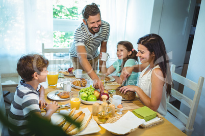 Happy family having breakfast together