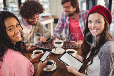 Group of friends using digital tablet and mobile phone Group of friends using digital tablet and mobile phone