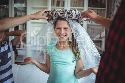 Girl imitating to be an angel by wearing a bubble wrap and an unpacked ring