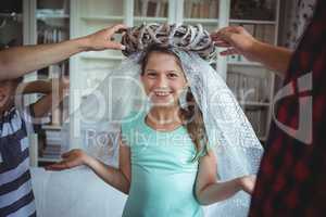 Girl imitating to be an angel by wearing a bubble wrap and an unpacked ring