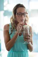 Woman drinking milkshake with a straw