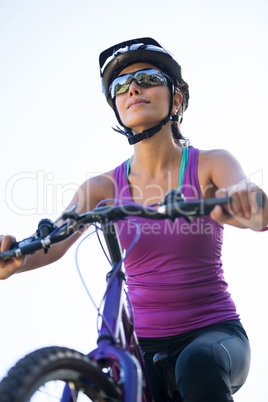 Female cyclist cycling in countryside