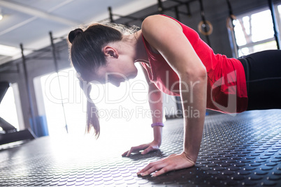 Female athlete doing push-ups in gym