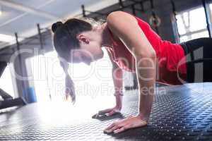 Female athlete doing push-ups in gym