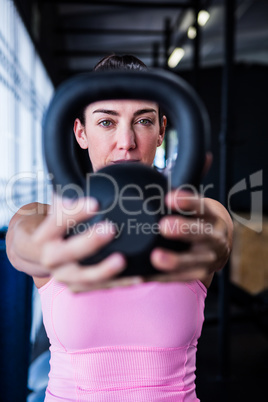 Portrait of serious athlete showing kettlebell