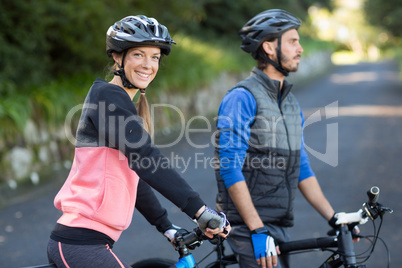 Biker couple with mountain bike on the road