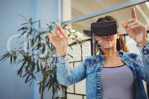 Low angle view of businesswoman enjoying augmented reality headset at office