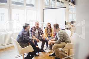 Creative business people sitting in meeting room