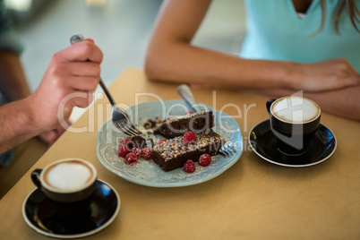 Couple eating pastry in cafÃ?Â©