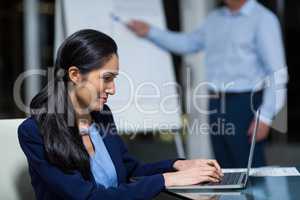 Portrait of businesswoman working on laptop