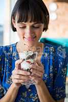 Woman holding a glass of dessert