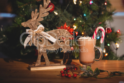Cup of coffee and christmas decoration on wooden table