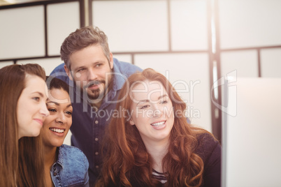 Happy business people using computer