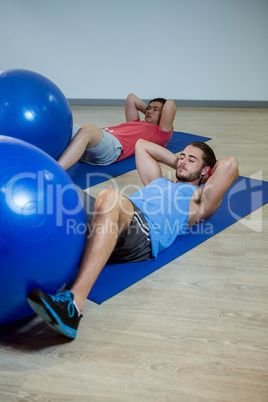 Men exercising on exercise mat