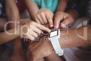 Family pointing at smart watch