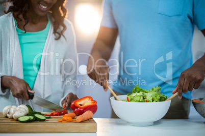 Mid-section of couple preparing food