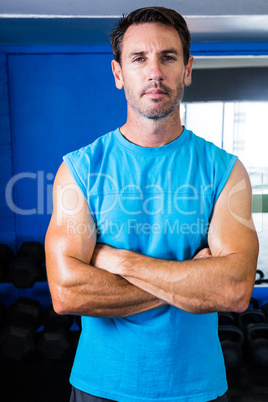 Portrait of serious athlete with arms crossed