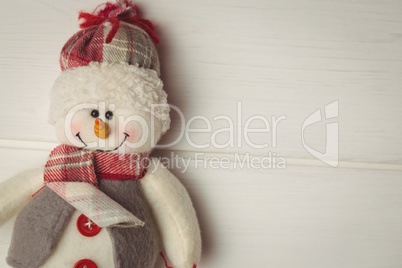 Close-up of snowman on wooden table