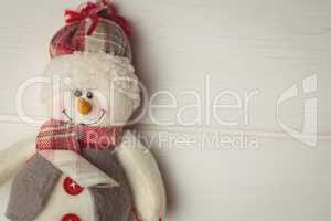 Close-up of snowman on wooden table