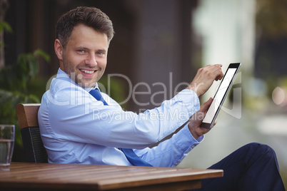 Portrait of businessman using digital tablet