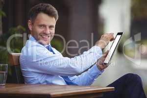 Portrait of businessman using digital tablet
