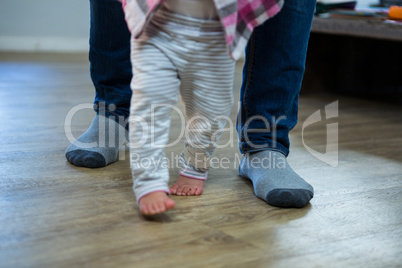 Father teaching a baby to walk