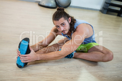 Portrait of man doing stretching exercise