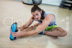 Portrait of man doing stretching exercise