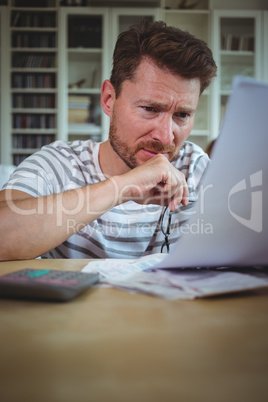 Worried man looking at his bills