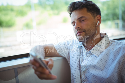 Handsome man listening music on mobile phone