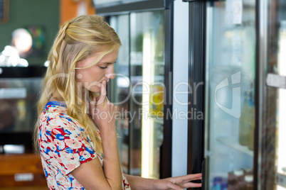 Woman looking at refrigerator