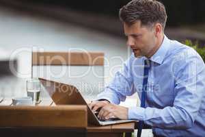 Handsome businessman using laptop