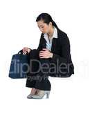 Depressed businesswoman sitting with handbag