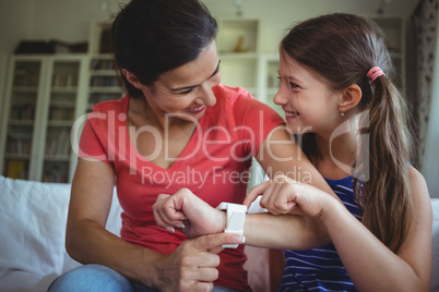 Smiling mother and daughter looking face to face