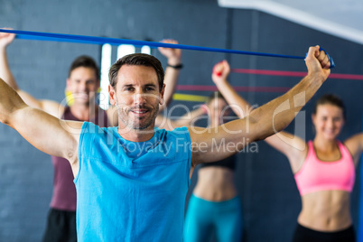 Male instructor with athletes in fitness studio