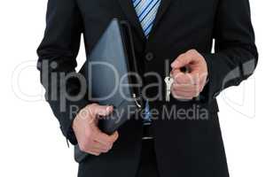 Mid section of businessman holding keys