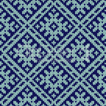 Knitting ornate seamless pattern in dark and light blue hues