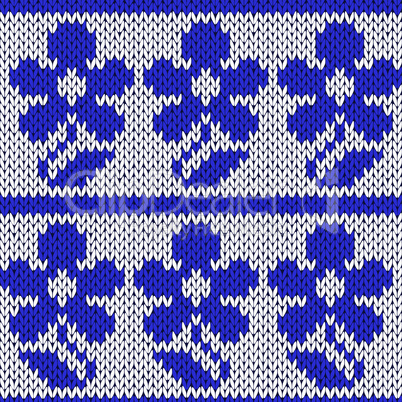 Knitting ornate seamless pattern with blue flowers
