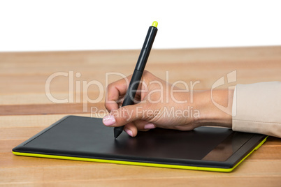 Hand of graphic designer using graphic tablet