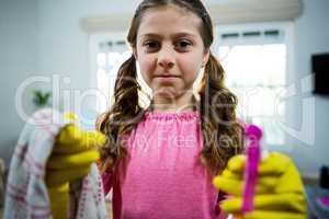 Portrait of girl holding cleaning products