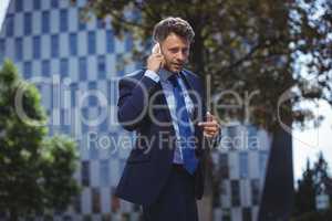 Handsome businessman talking on mobile phone