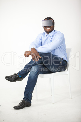 Man sitting on chair and using virtual reality headset