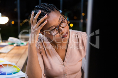 Businesswoman working on computer at her desk