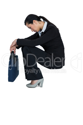 Depressed businesswoman sitting with handbag