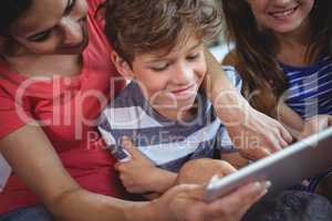 Mother and kids using digital tablet together