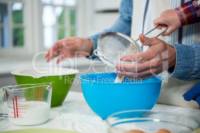 Father and son preparing cupcake