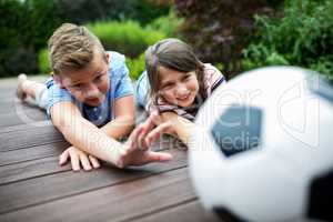 Kids playing with football on jetty